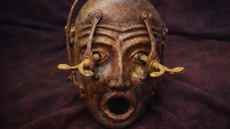 Aged bronze mask with mechanical details