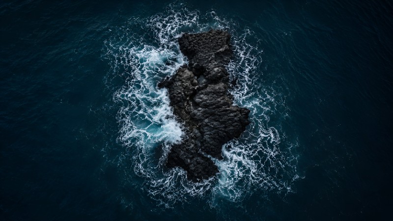 Jagged rock in turbulent ocean